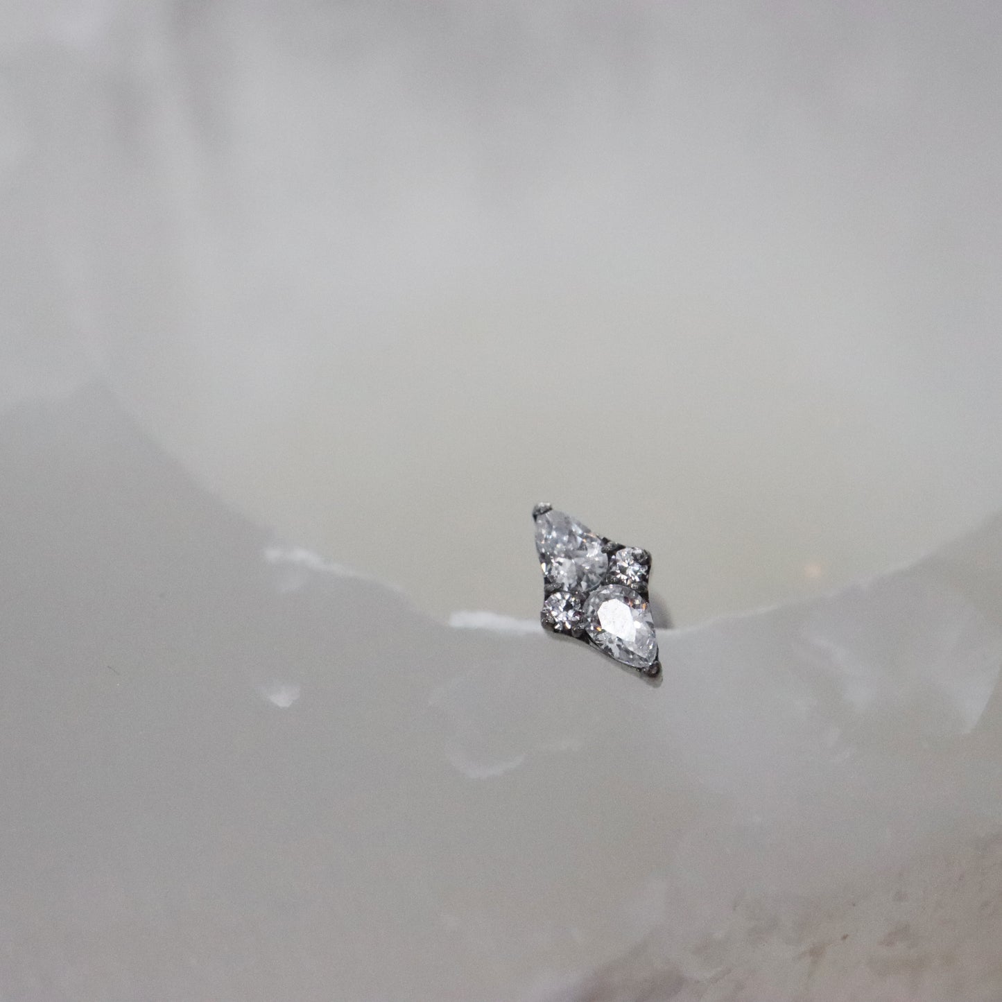 Gold stud earrings with a sparkling marquise diamond