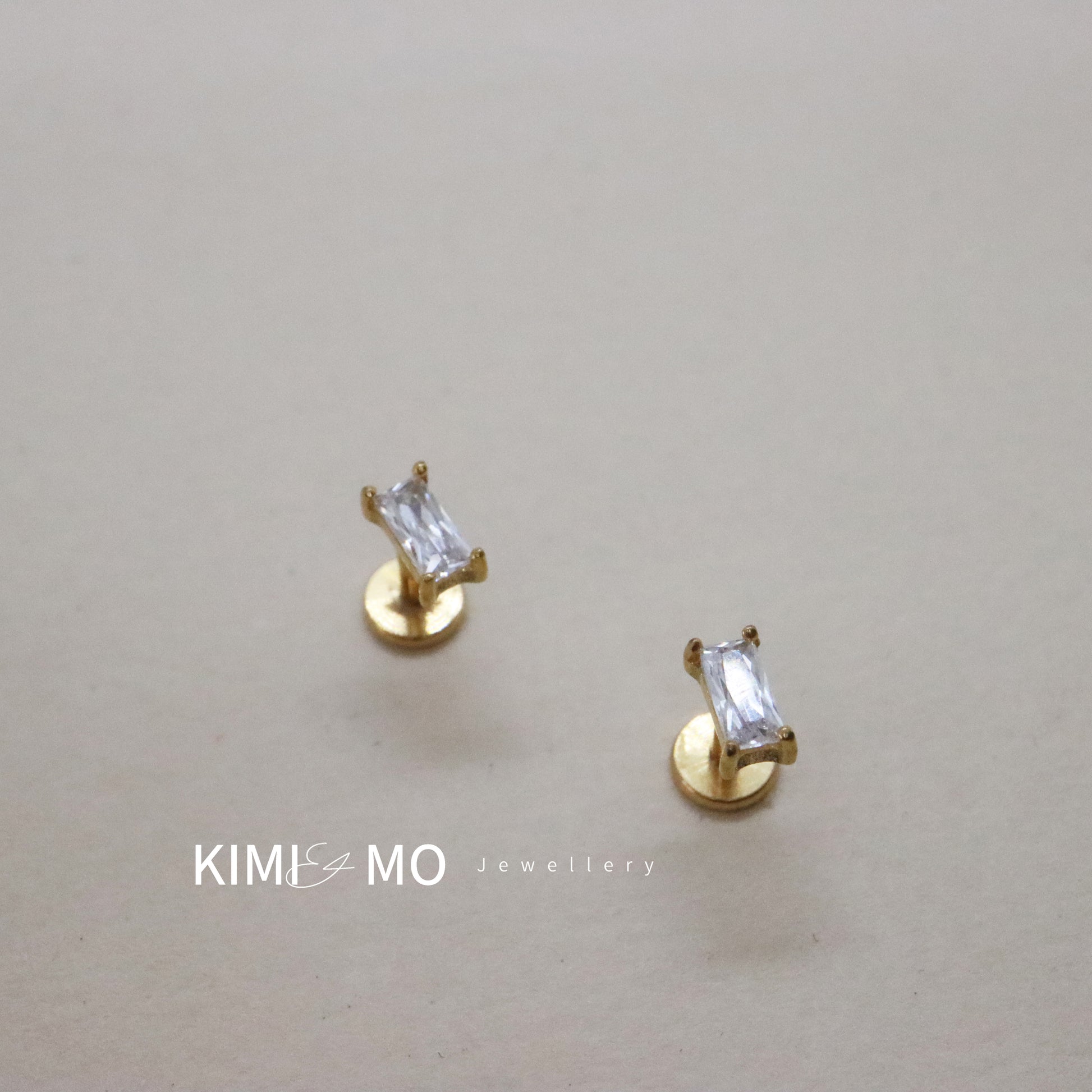 Minimalist gold bar stud earrings with sparkling gemstone