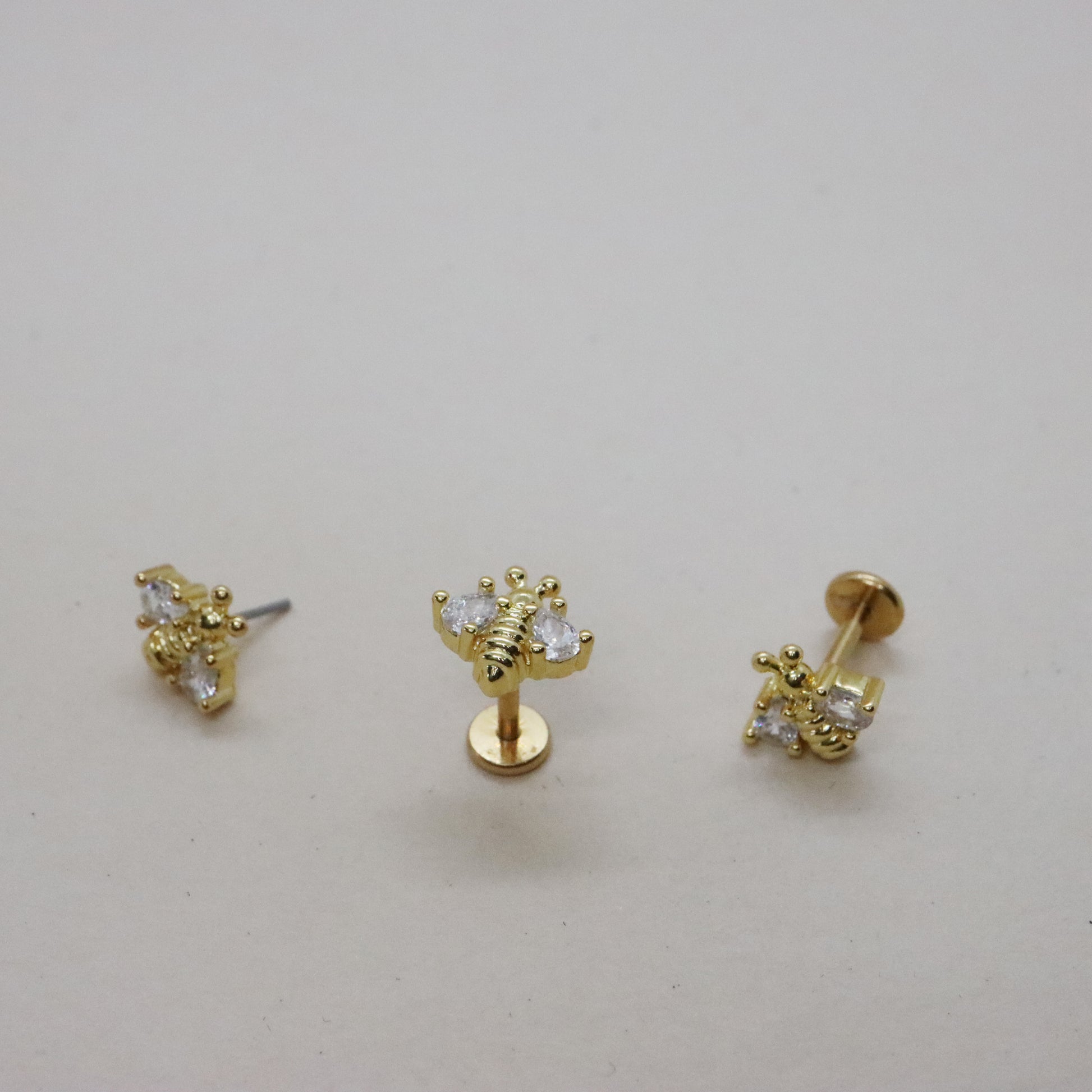 Charming bee-shaped gold earrings with sparkling gemstones