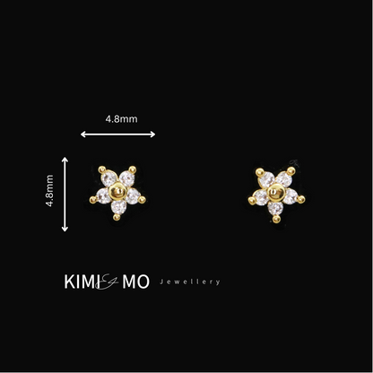 Dainty gold flower stud earrings with crystal accents for a delicate look