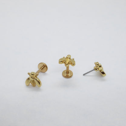 Elegant bee-shaped threadless stud earrings on white