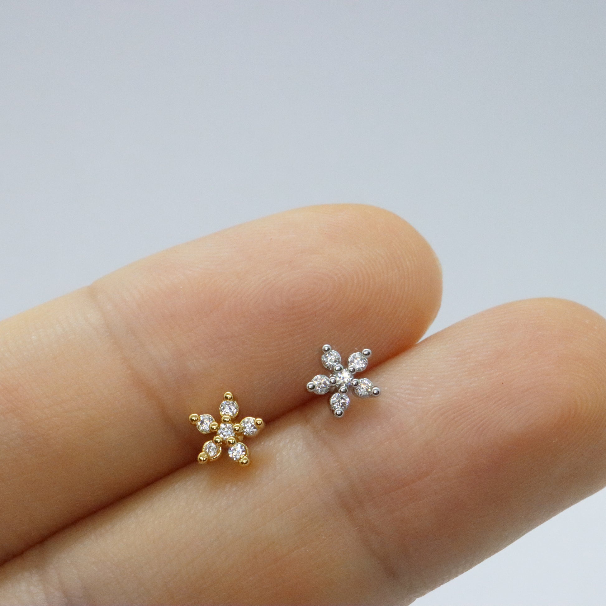 Versatile gold floral stud earrings with a touch of sparkle