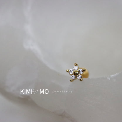 Elegant gold stud earrings shaped like tiny blooms with gemstone detail