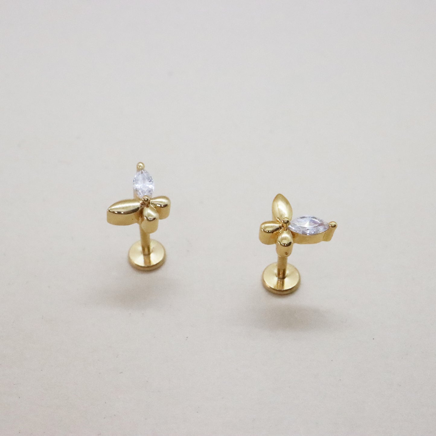 Gold butterfly stud earrings with gemstone accents