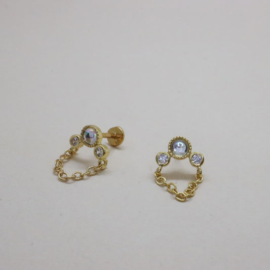 Gold chain-linked stud earrings with diamond accents