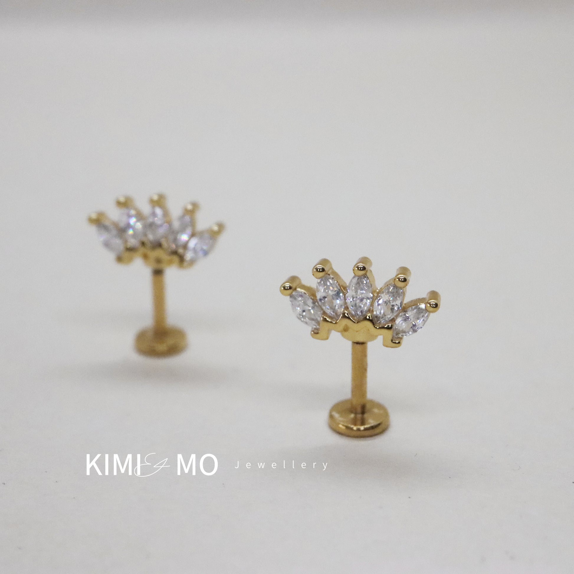 Gold crown-inspired gemstone earrings with radiant cut stones