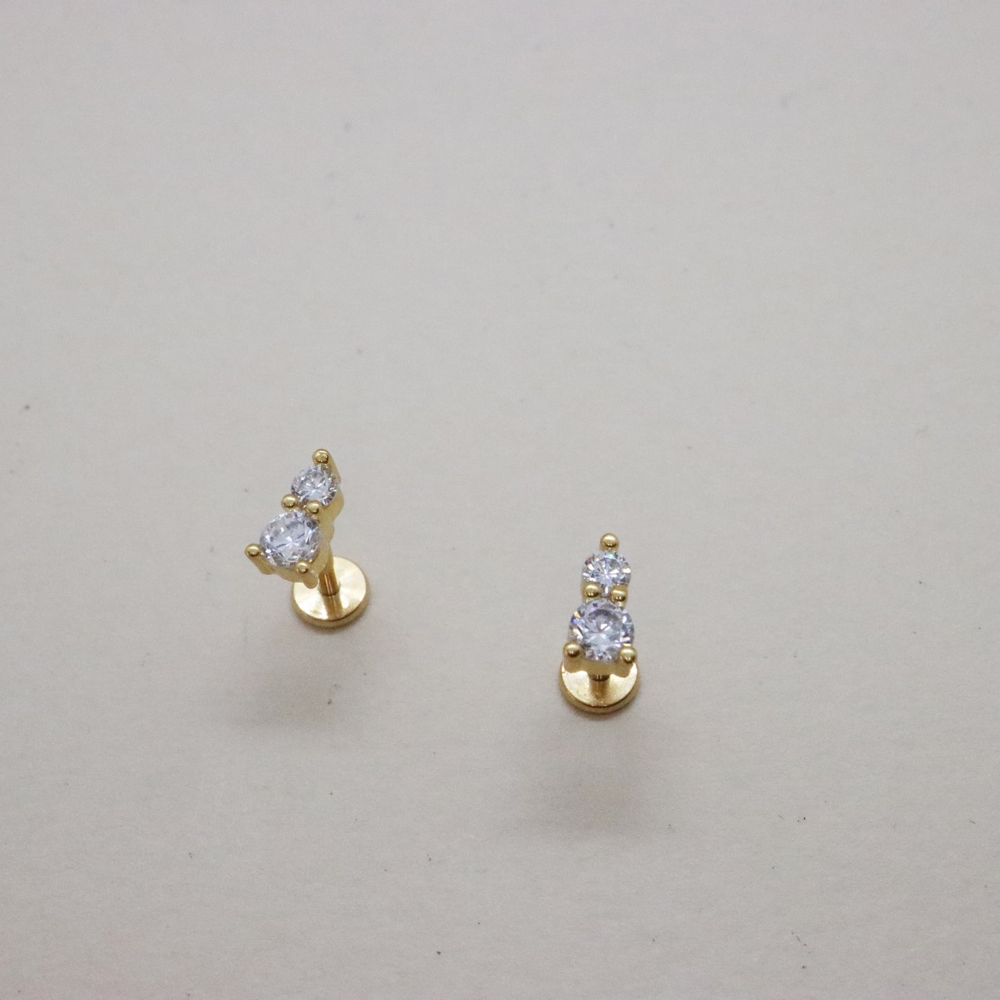 Elegant two-stone push pin stud earrings on white background