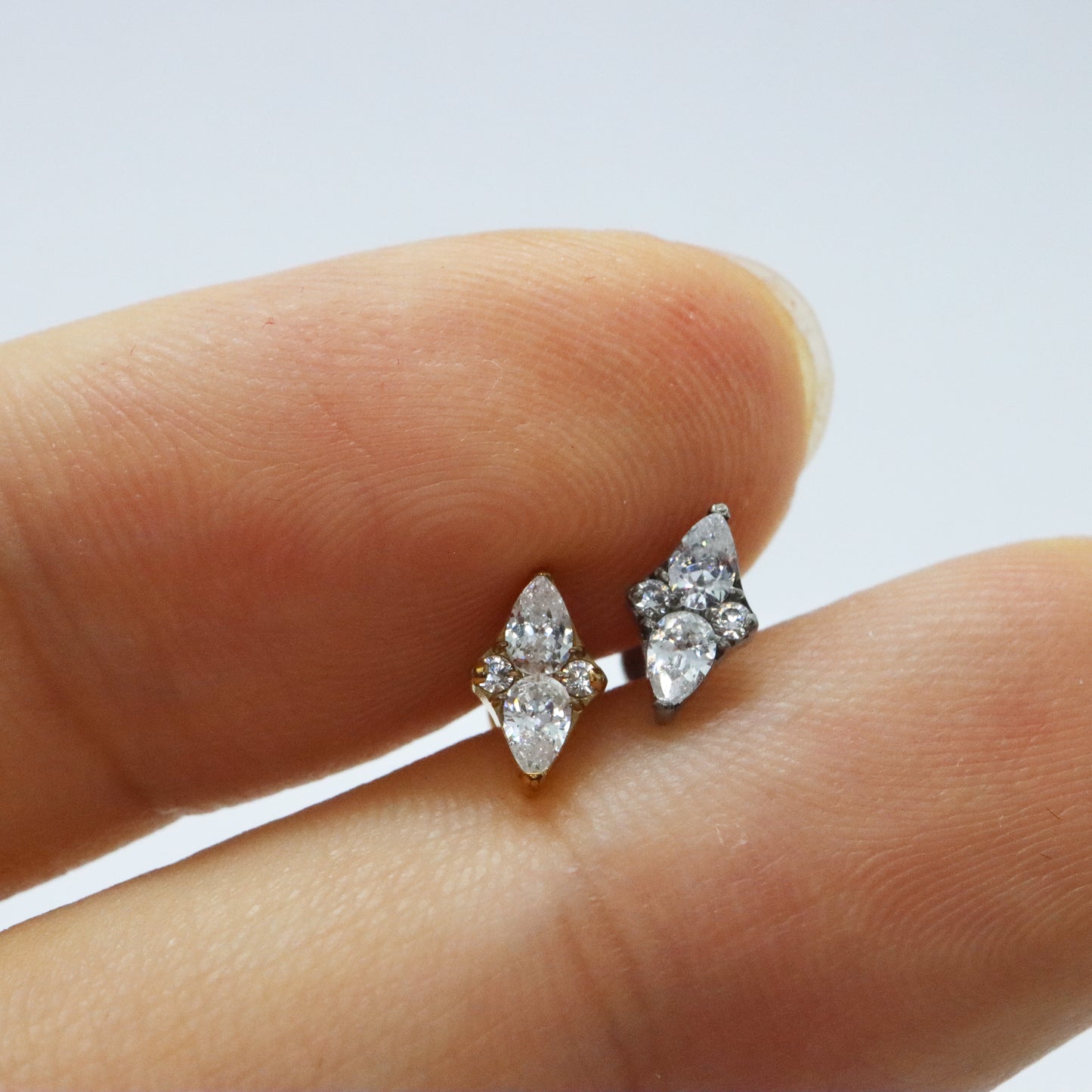 Luxurious gold and silver stud earrings with clear diamond