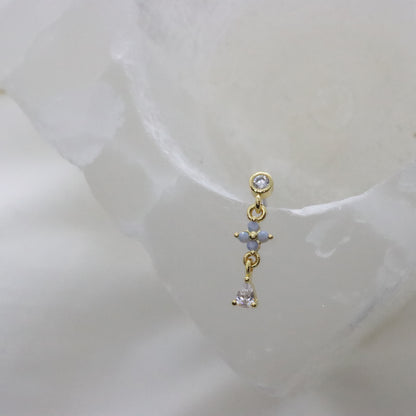 Minimalist gold earring with a flower design and gemstone detail