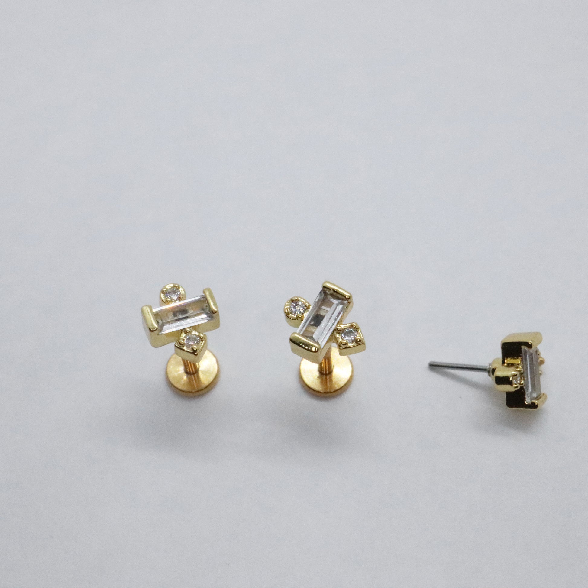 Minimalist gold stud earrings with geometric gemstone