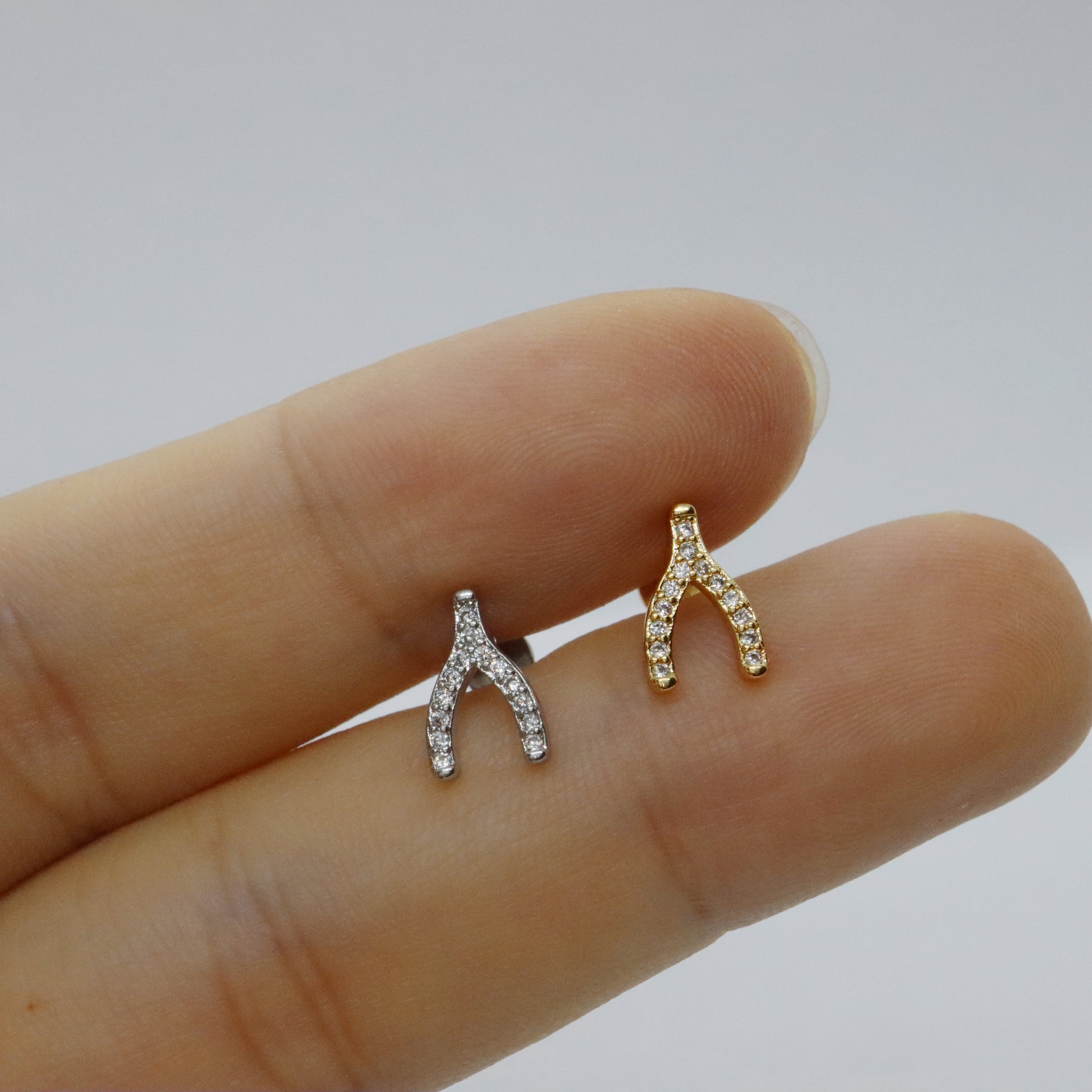 Modern wishbone stud earrings in gold with gemstone detailing