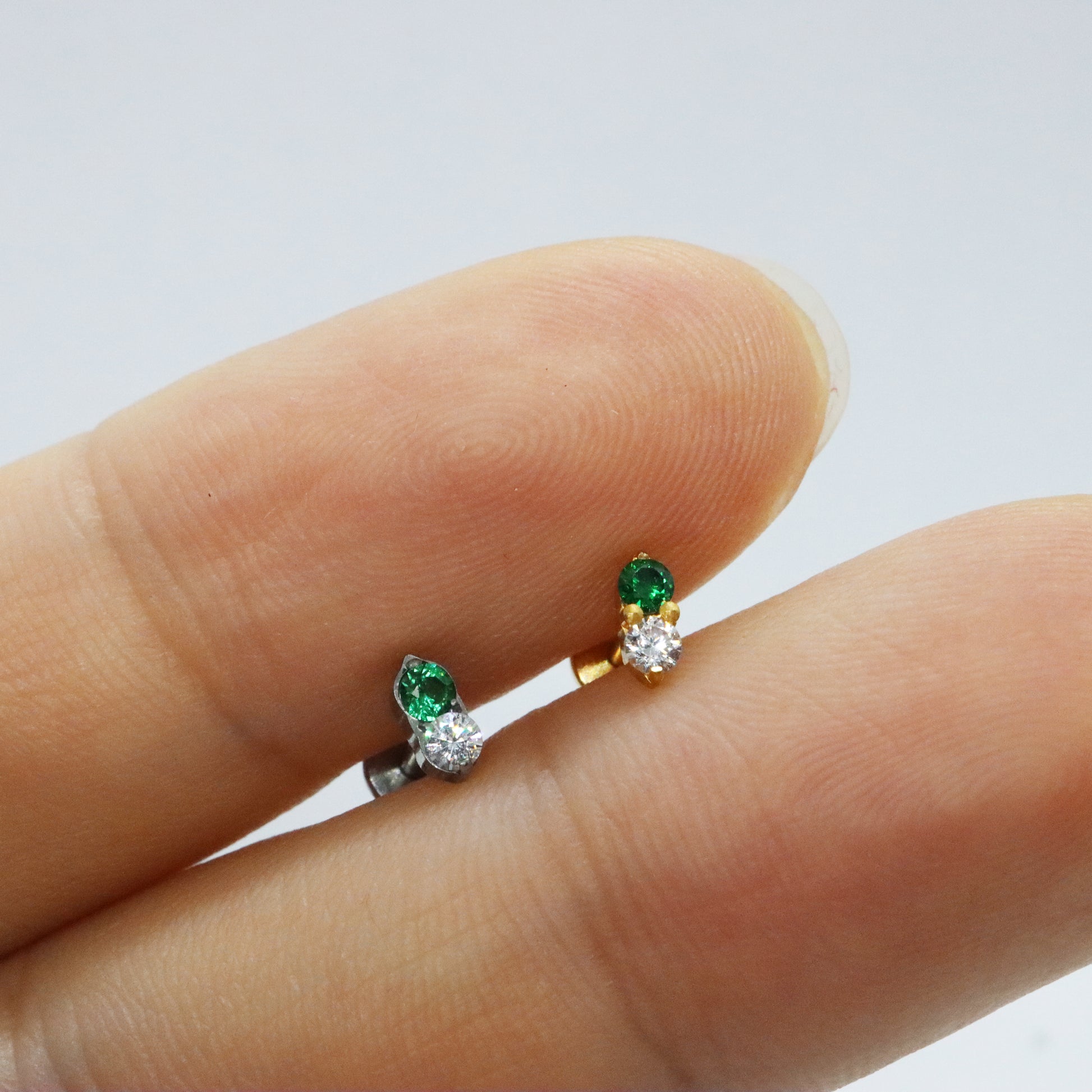 Nature-inspired gold stud earrings with emerald and diamond