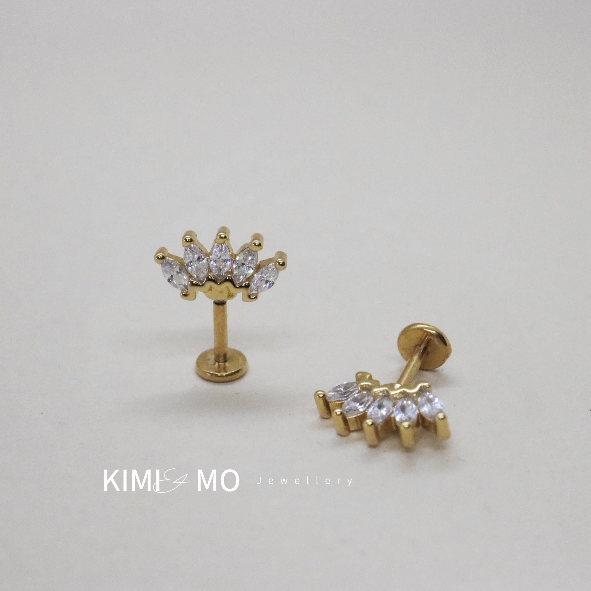 Regal gold stud earrings with a semi-circle of sparkling gems