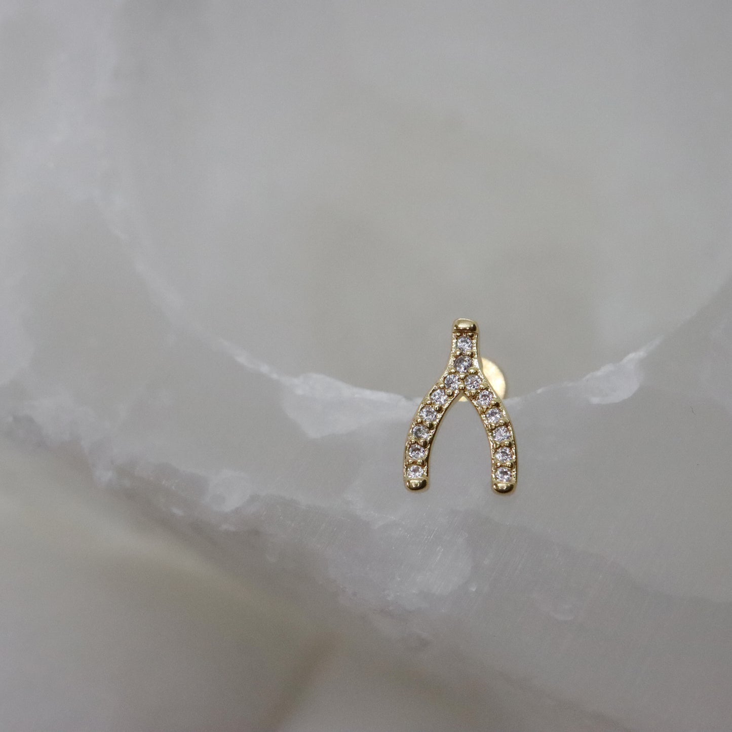 Stylish gold stud earrings with wishbone silhouette