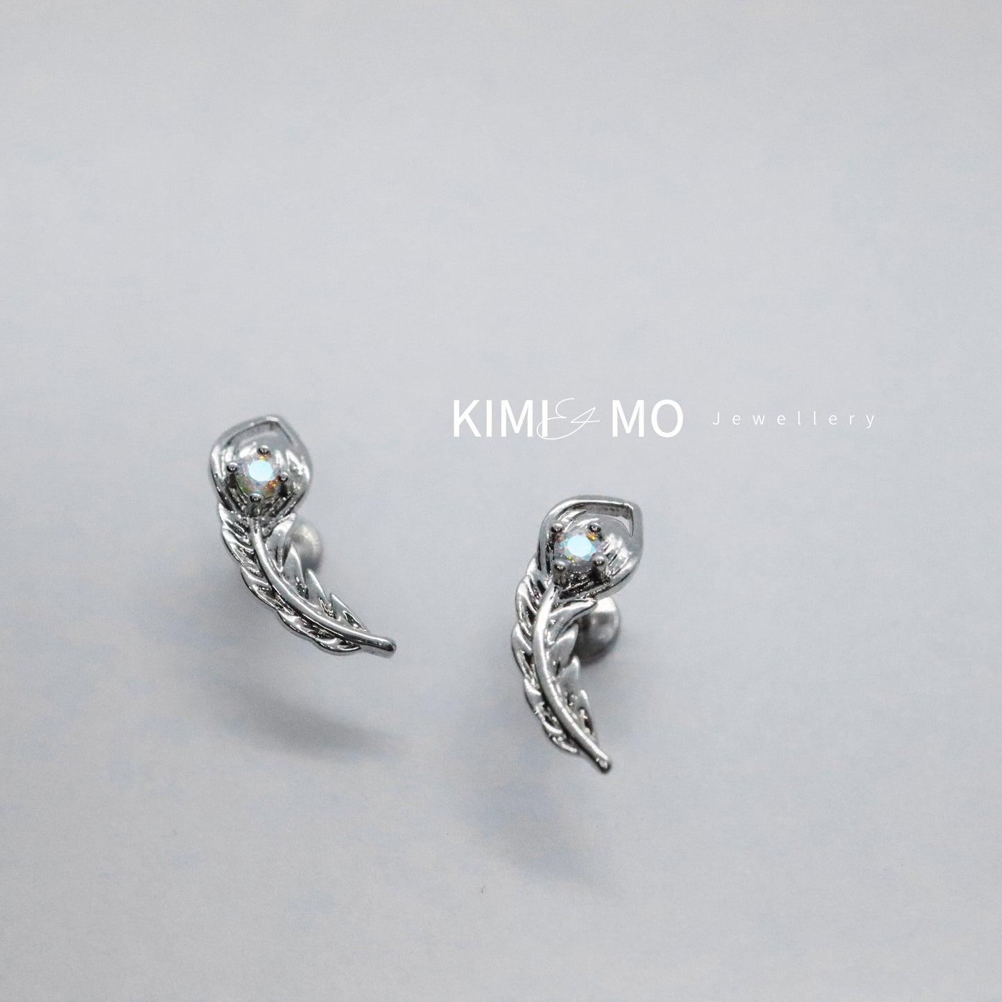 Stylish silver avian stud earrings with unique gem detail