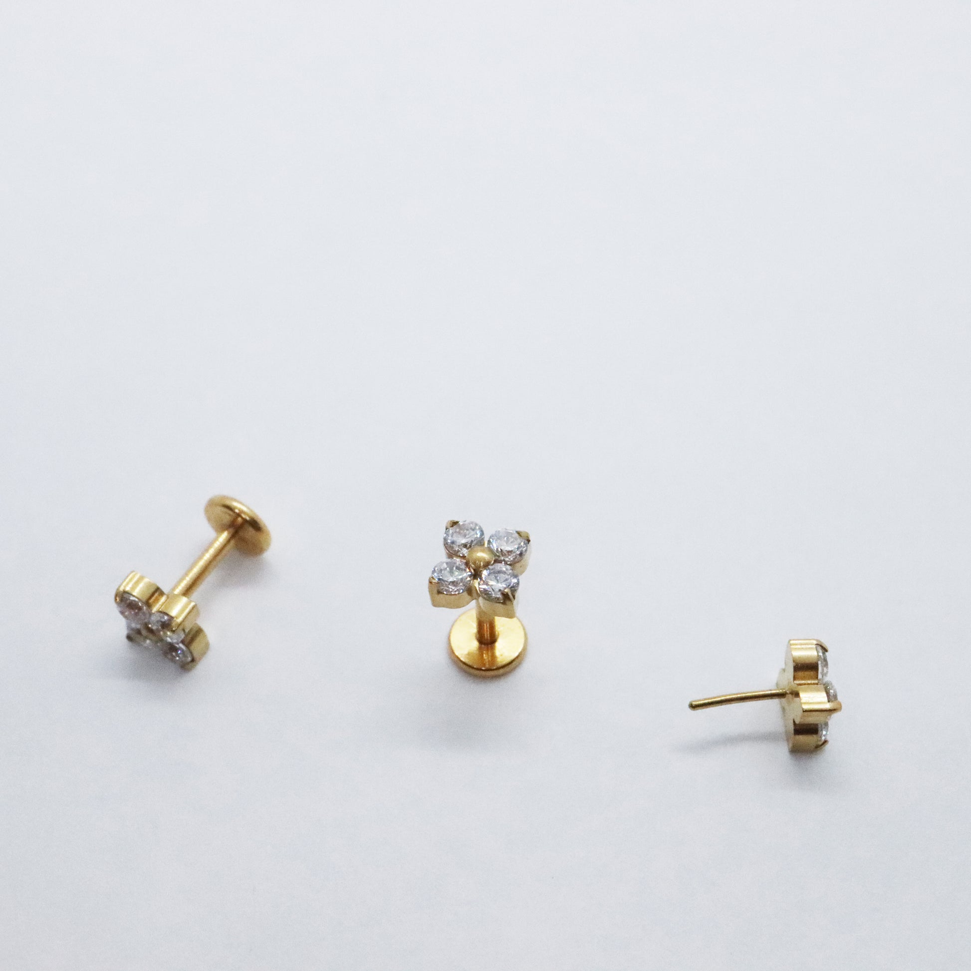 Timeless gold flower stud earrings with sparkling gemstones