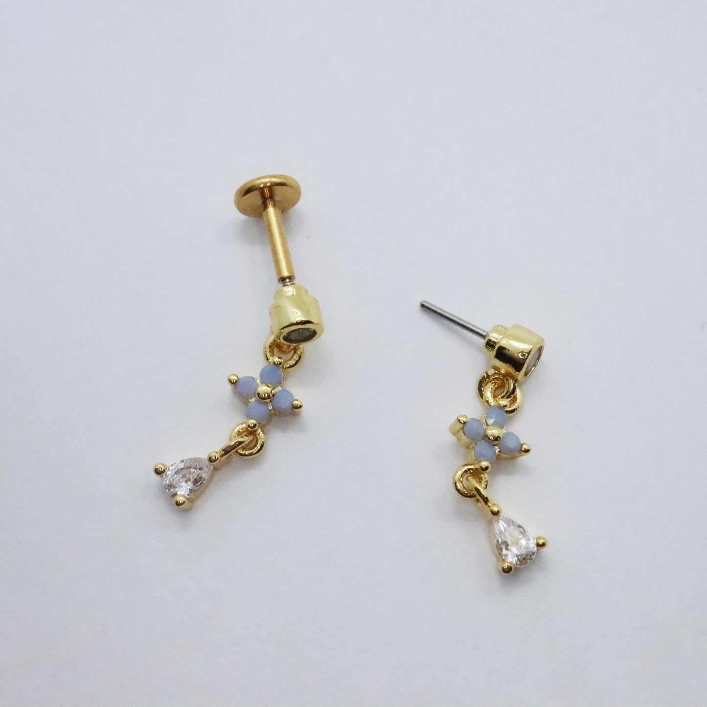 Trendy gold flower earring with a threadless design and gemstone embellishments